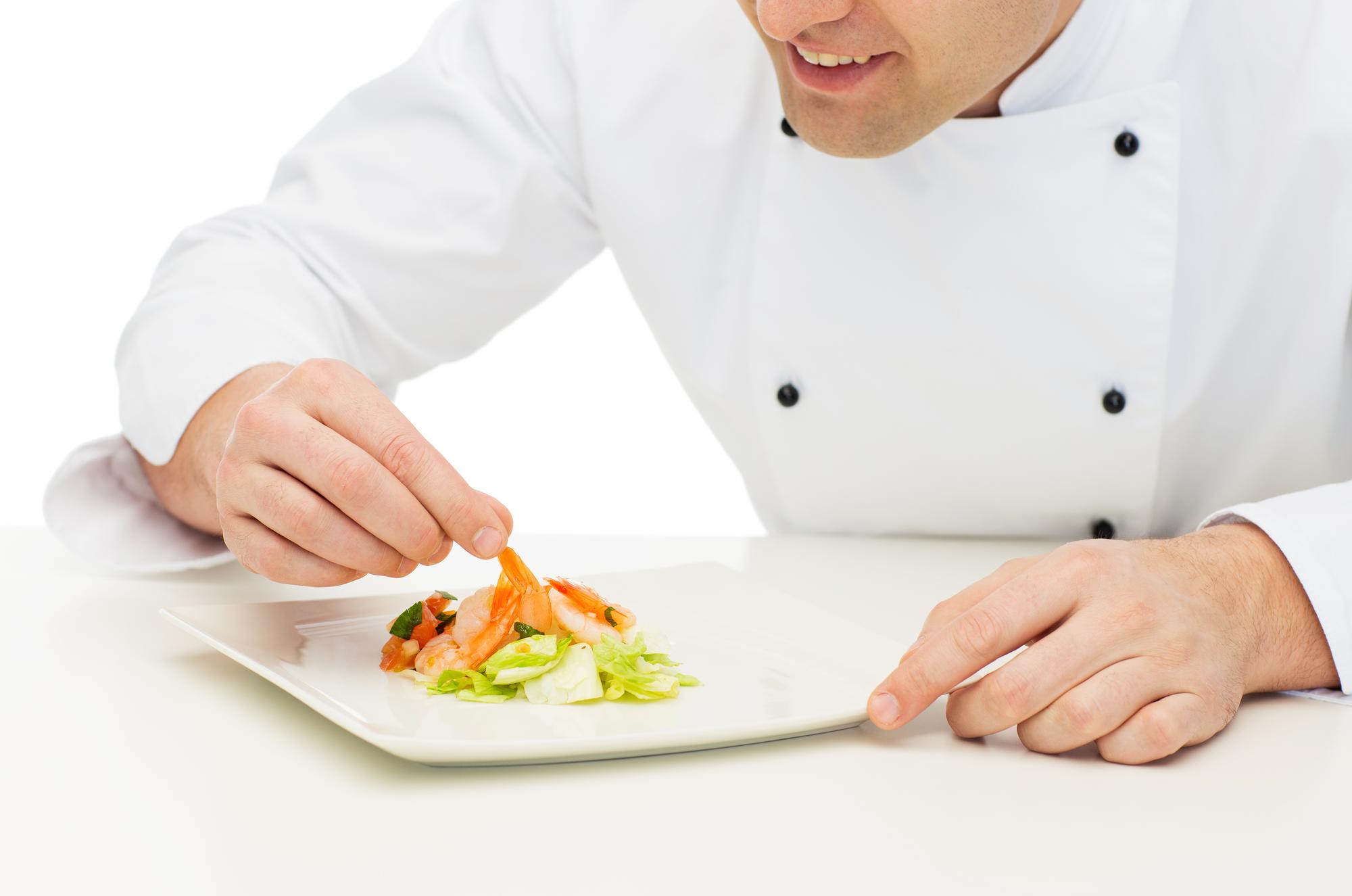 Student plating a dish during online class
