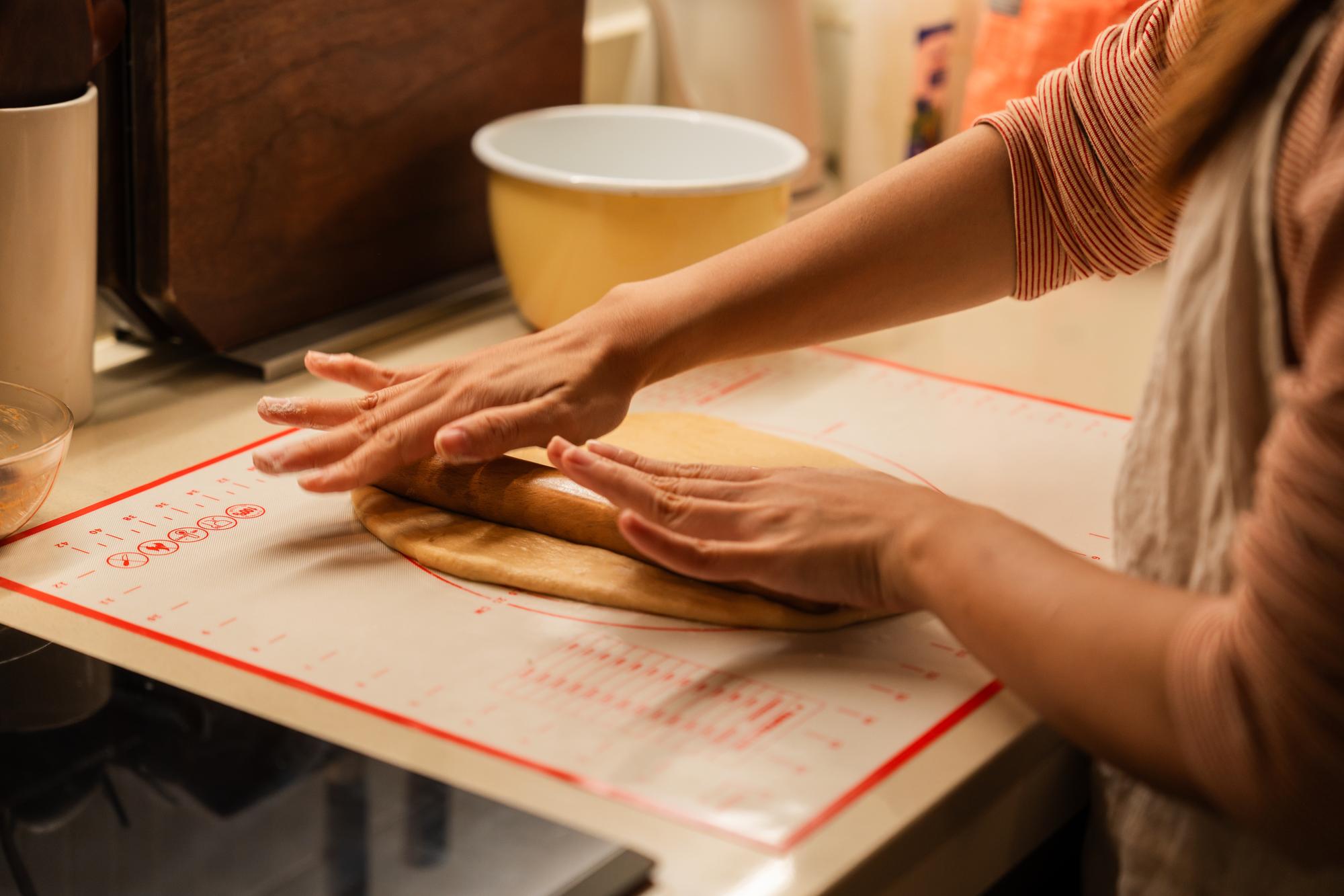 Close-up on hands kneading dough with notes